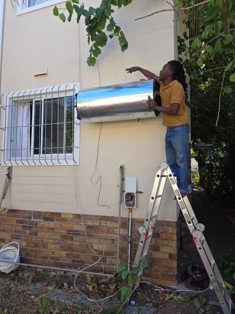 JBM technician installing geyser